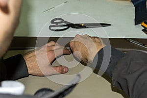 A male worker does skinning a genuine leather of