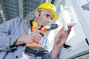Male worker drill window