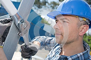 male worker erecting scaffolding
