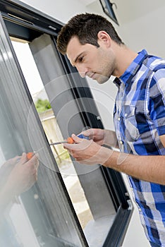 Male worker fitting modern windows