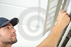 male worker fixing airconditioning