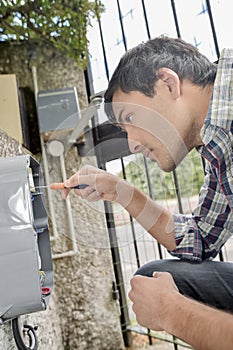 Male worker fixing meter