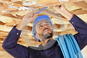 Male worker holding cables