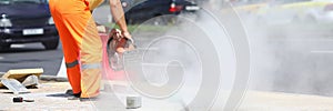 Male worker holds gas cutter in his hands and cuts concrete.