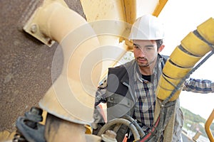 Male worker inspecting pipes photo