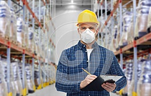 Male worker in mask with clipboard at warehouse