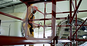 Male worker moving down from scaffolding at solar station 4k