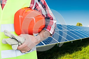 Male worker at photovoltaic panels