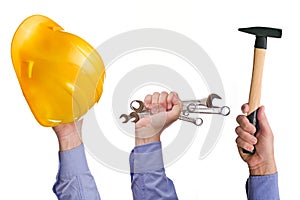 Male worker's hand holding various craft trade tools