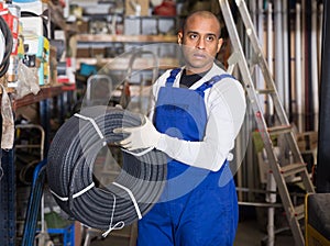 Male worker stocks plastic corrugation at store photo