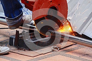 Male Worker Use Chop Saw to Cutting a Thick Stainless Steel Tube