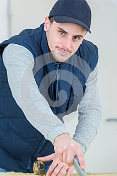 Male worker using stanley knife