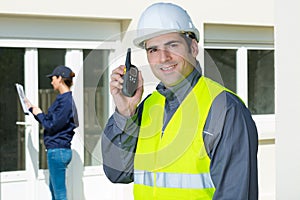 Male worker using walkie-talkie photo