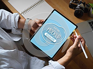 Male worker working with mock up digital tablet on worktable in office room