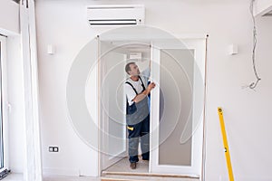 Carpenters installing glass door with a wooden frame photo