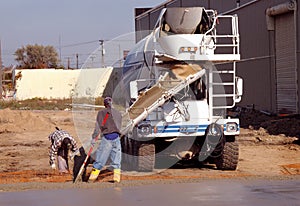 Male Workers Pouring Cement