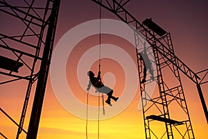Male working abseiling on a construction