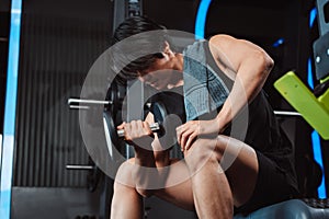 Male working out Bodybuilder with dumbbell weights at the gym.man bodybuilder doing exercises with dumbbell. training sport