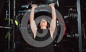 Male working out Bodybuilder with dumbbell weights at the gym.man bodybuilder doing exercises with dumbbell. training sport