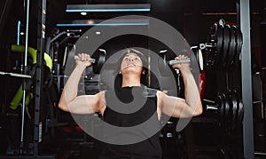 Male working out Bodybuilder with dumbbell weights at the gym.man bodybuilder doing exercises with dumbbell. training sport