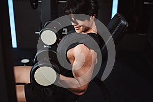 Male working out Bodybuilder with dumbbell weights at the gym.man bodybuilder doing exercises with dumbbell. training sport