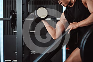 Male working out Bodybuilder with dumbbell weights at the gym.man bodybuilder doing exercises with dumbbell. training sport