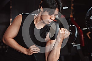 Male working out Bodybuilder with dumbbell weights at the gym.man bodybuilder doing exercises with dumbbell. training sport