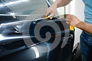 Male wrapper holds sunscreen film, car tinting