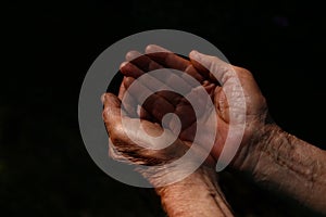 Male Wrinkled old hands begging asking for money, help