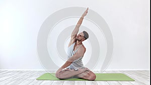 Male yoga meditates in classical pose in studio over white background