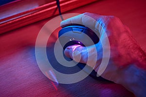 A male young hand lying on ergonomic gamer vertical mouse for computer seen from above. These types of mouses help to prevent