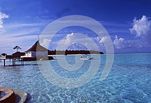 Maledives: A boat at the beach of Rihivelli Island in the Ari At