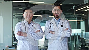 Males physician standing with crossed arms on background of glass cabinet window