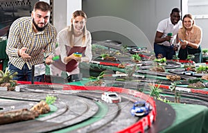 males and women play in childrens racing track