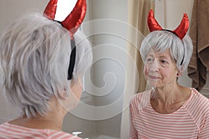 Malevolent senior woman with demon horns