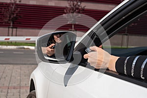 Malfunctions with the automatic system of a barrier, the female hand with the panel opens gate from the car