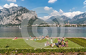 People resting on the Lakefront of Malgrate located on the shore of Como Lake in province of Lecco.