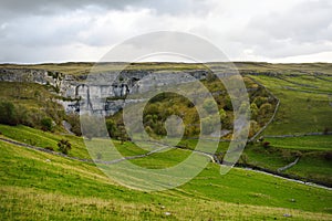 Malham Cove, a huge curving amphitheatre shaped cliff formation of limestone rock in Yorkshire Dales National Park in northern