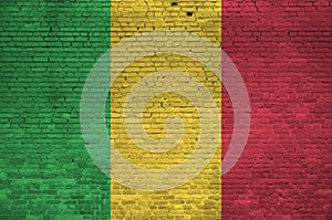 Mali flag depicted in paint colors on old brick wall. Textured banner on big brick wall masonry background