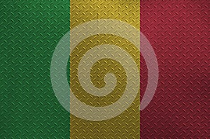 Mali flag depicted in paint colors on old brushed metal plate or wall closeup. Textured banner on rough background
