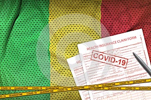 Mali flag and Health insurance claim form with covid-19 stamp. Coronavirus or 2019-nCov virus concept