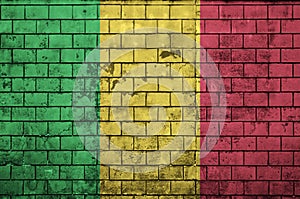 Mali flag is painted onto an old brick wall