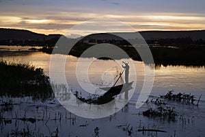 Malian Fishermen Hauling His Fishing Net At A Late Sunset In Bamako