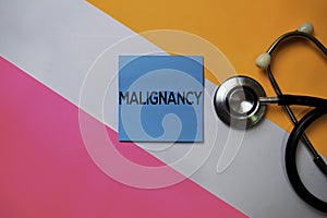 Malignancy text on sticky notes with color office desk. Healthcare/Medical concept photo