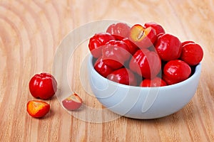 Malpighia glabra (red acerola), tropical fruit in bowl