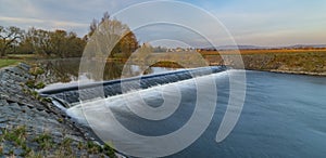 Malse river with big weir before sunrise in Budweis city