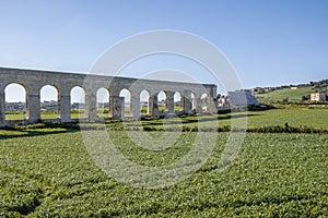 Malta, The Aqueducts on the side of the Victoria in Gozo, maltese landscape with the fresh vegetable field and blue sky