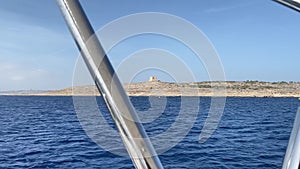 Malta boat tour, sailing around Comino island with Comino tower on top