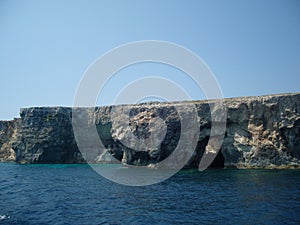 Malta coast limestone steep coastal slopes with geomorphological layers and caves