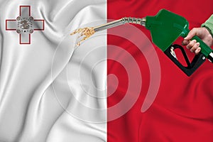 MALTA flag Close-up shot on waving background texture with Fuel pump nozzle in hand. The concept of design solutions. 3d rendering